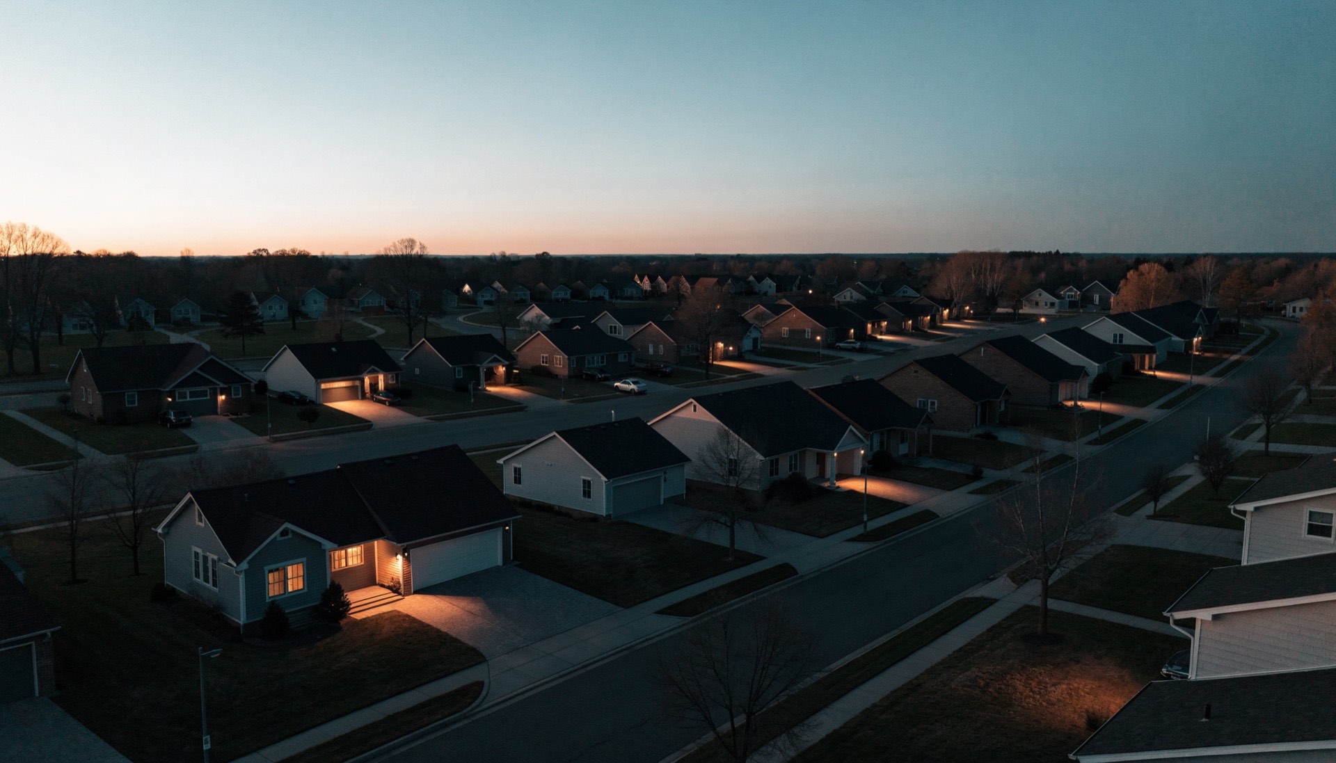 Aerial view of a suburban neighborhood at dusk
