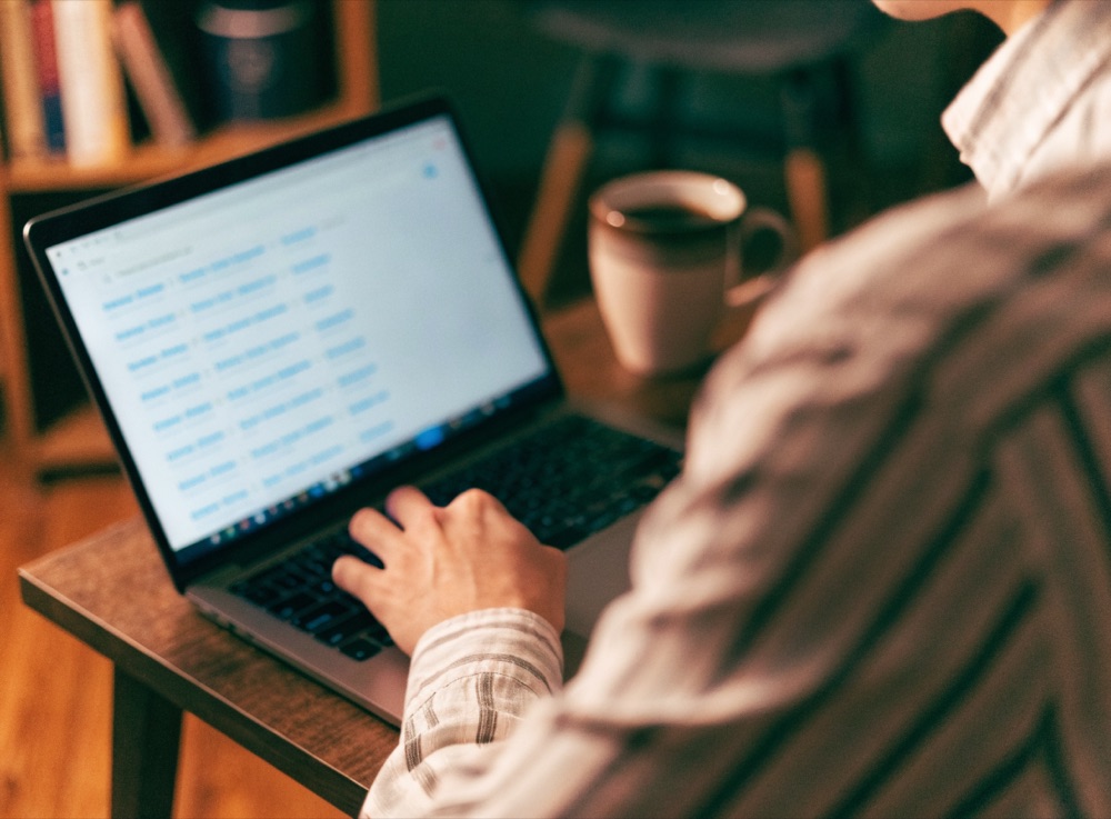 Homeowner searching Google on a laptop at a home office desk